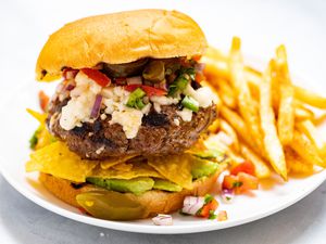 Nacho Mexican Burger with a side of fries.