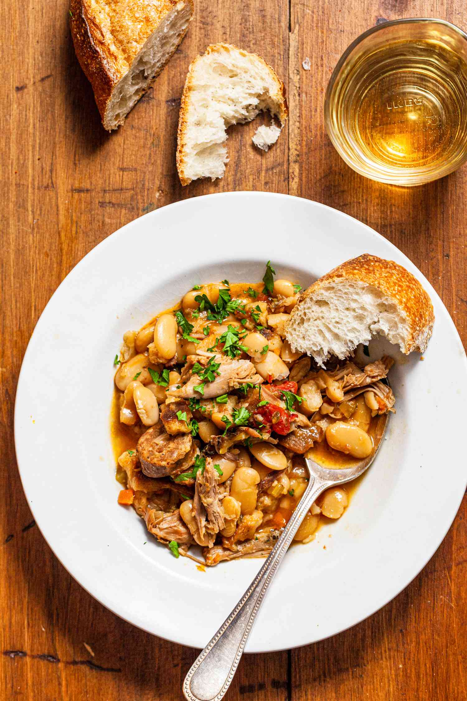 Bowl of cassoulet with bread. 