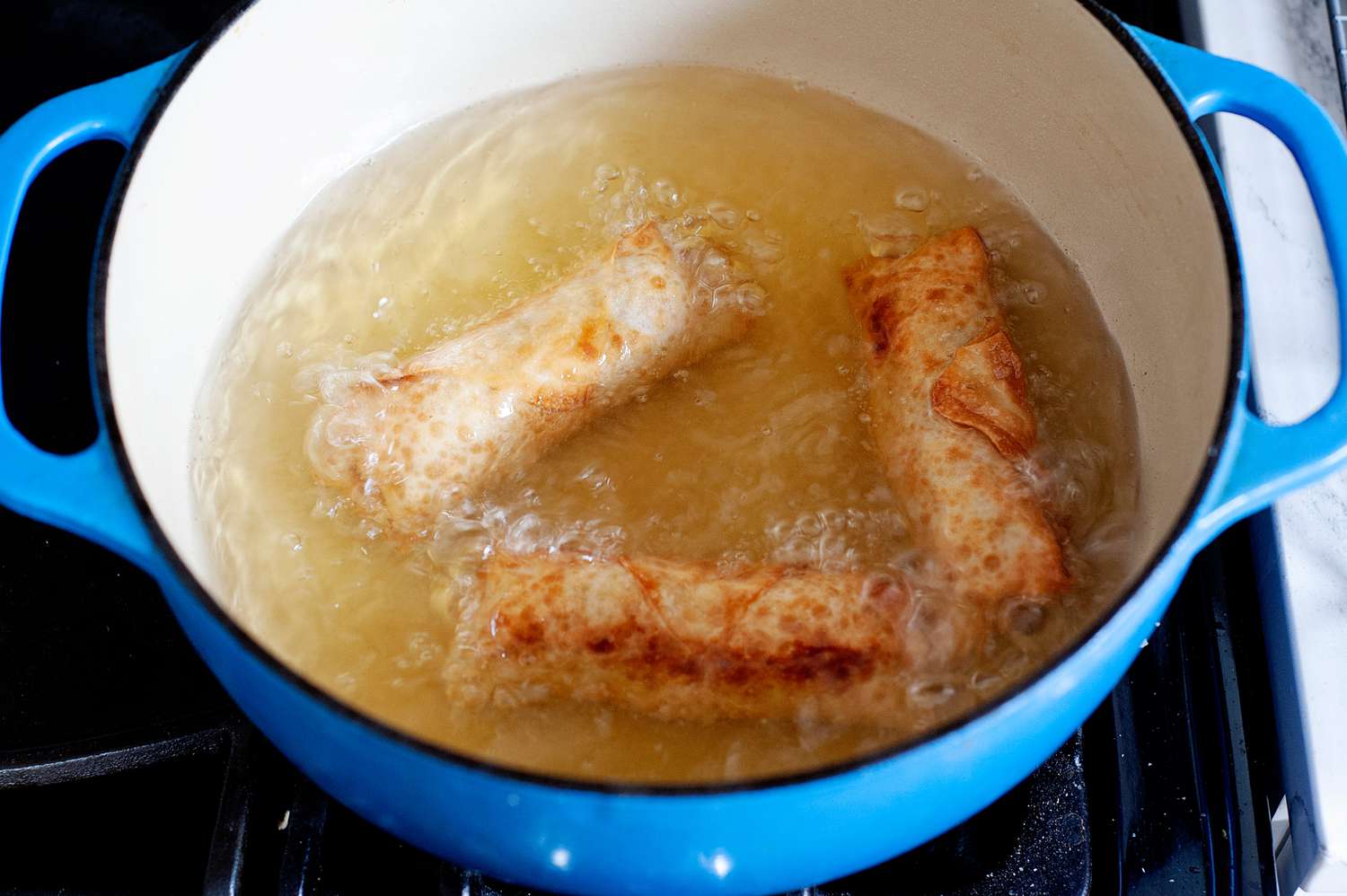Vegetarian egg rolls frying.