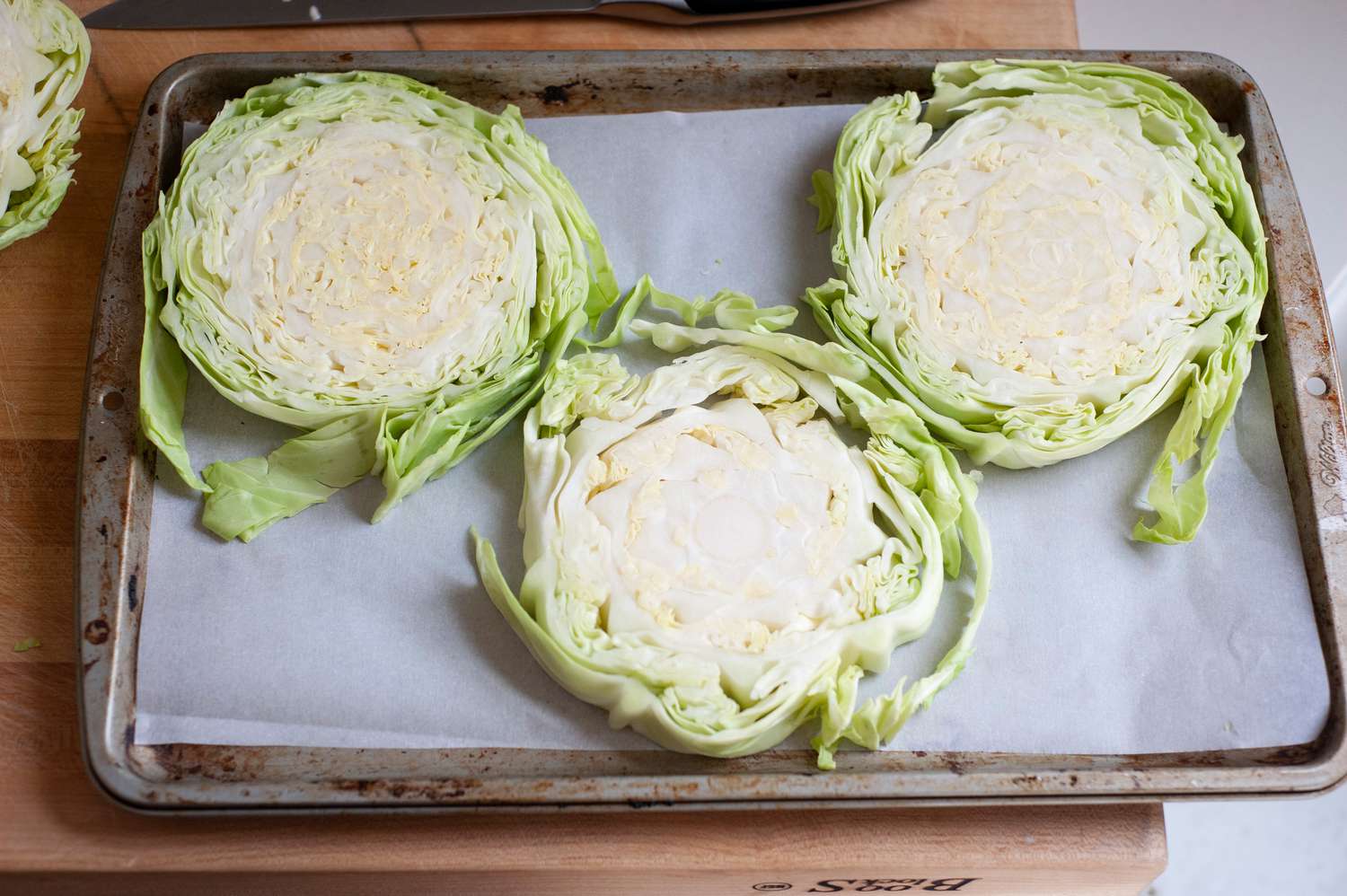 Overhead view of sliced cabbage steaks.