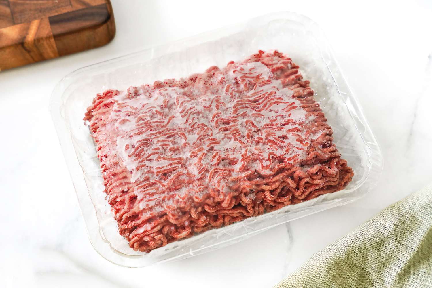 Frozen Ground Beef in a Plastic Wrapped Meat Container