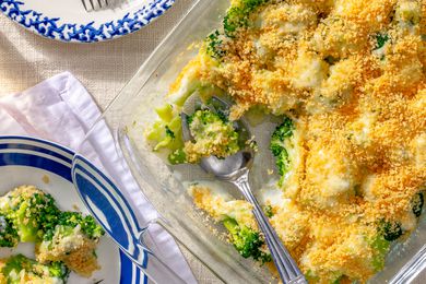 My Mom’s Famous Broccoli Cheese Casserole in a dish, one serving scooped out and added to a plate