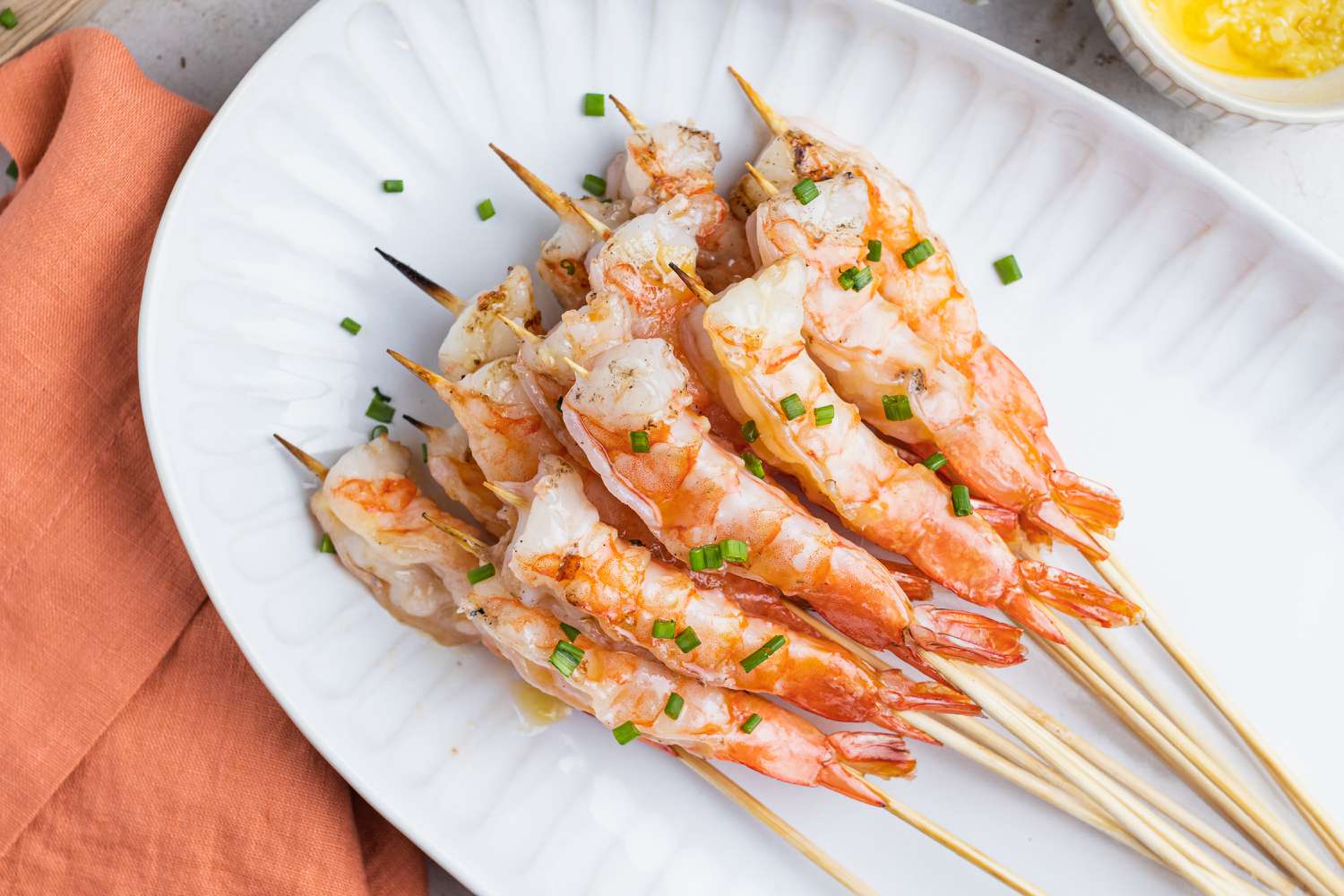 Overhead view of grilled garlic shrimp on a platter.