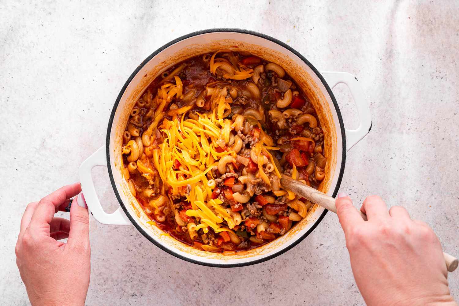 Shredded Cheddar Cheese Stirred Into the One-Pot Taco Pasta 