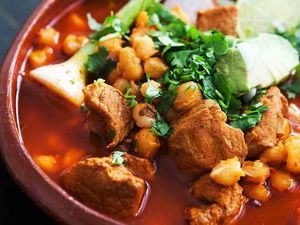 Pork Pozole with Red Chilies in a red bowl