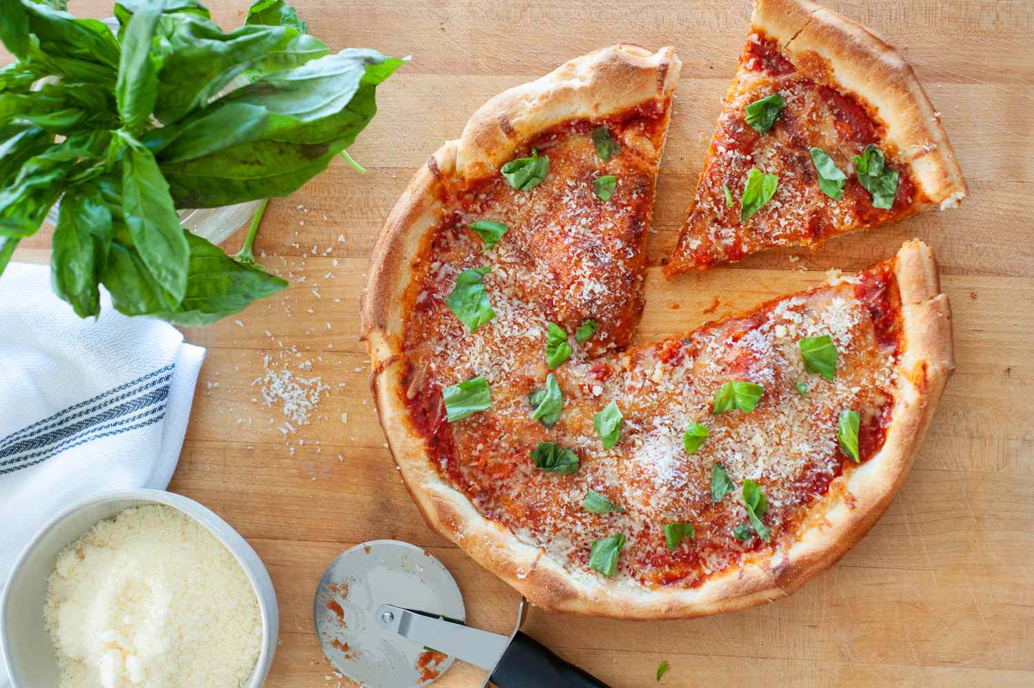 Cast iron skillet pizza with a slice cut.