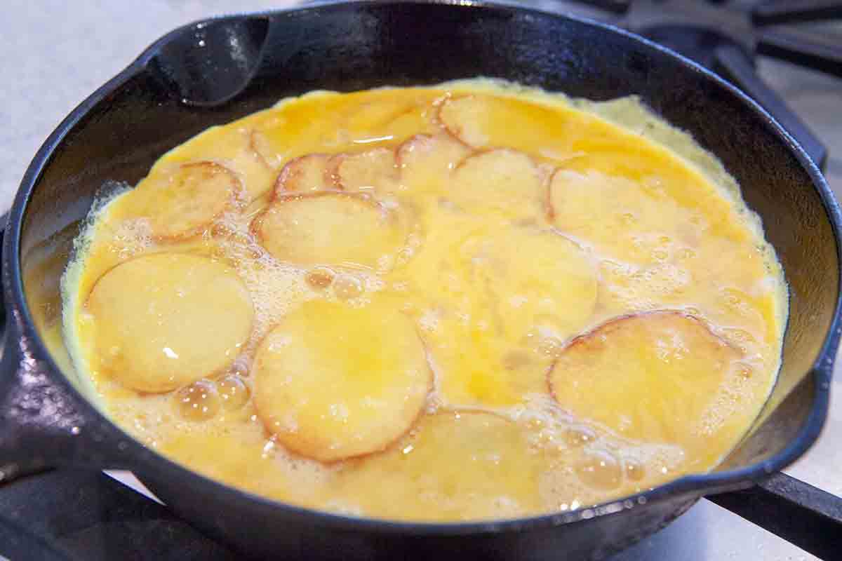 cook spanish tortilla in cast iron pan until eggs set