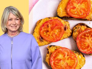 Martha Stewart next to a plate of tomato-topped welsh rarebit toasts