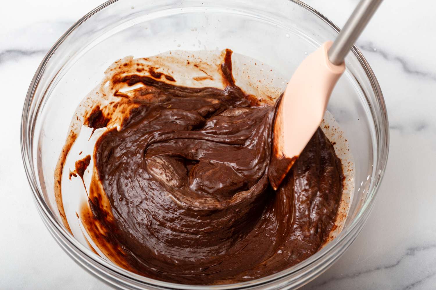 Ganache in a glass bowl to show how to make chocolate truffles.