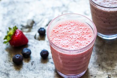 Banana Smoothie with berries on countertop
