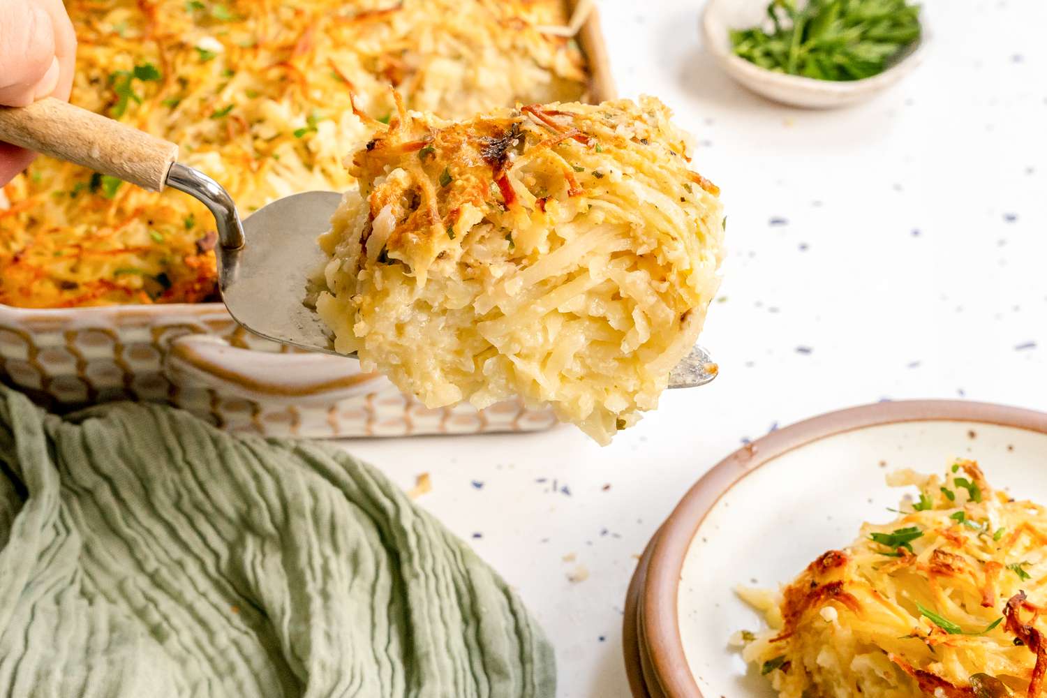 Serving of Potato Kugel on a Pie Server, Moved from Casserole Dish to a Plate 
