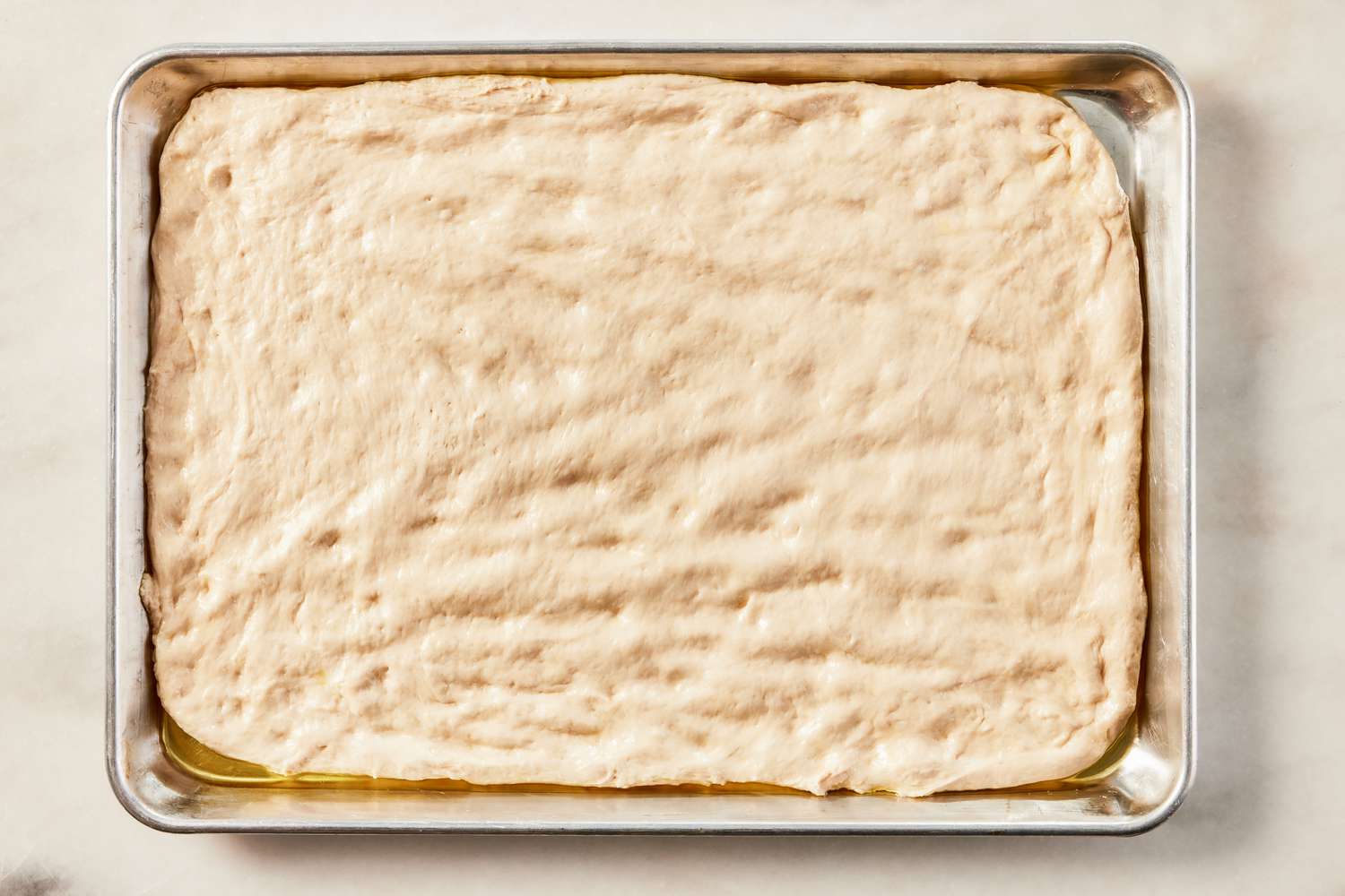 granma pizza dough added to a sheet pan