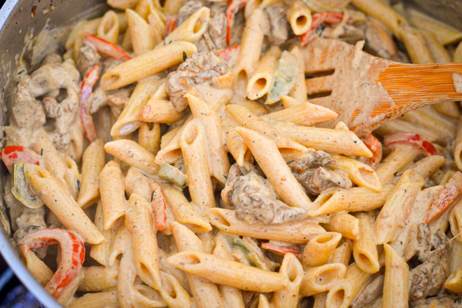 Rasta Pasta with Jerk Chicken Stirred in a Pot 