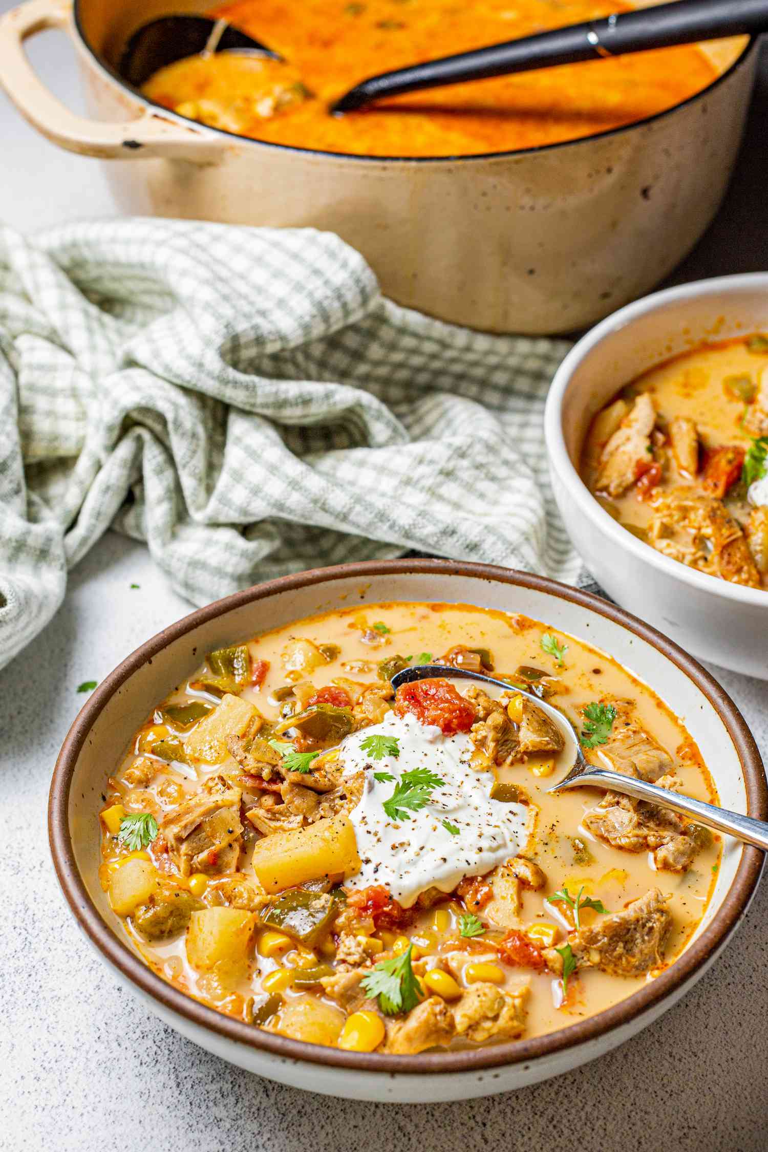 Bowl of Chipotle Chicken Chowder with More in a Pot in the Background