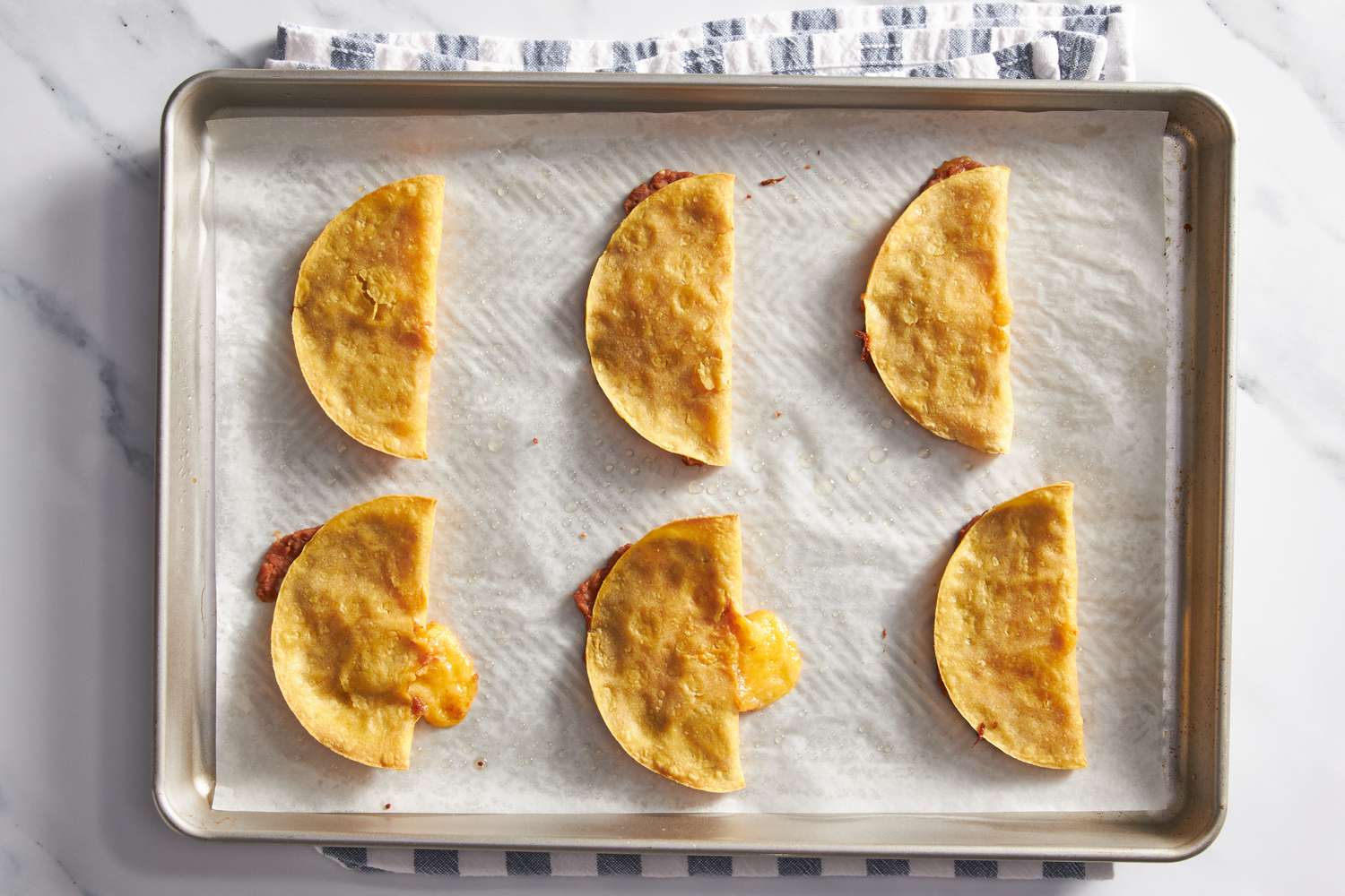 Cheesy baked tacos on a baking sheet for cheesy baked taco recipe