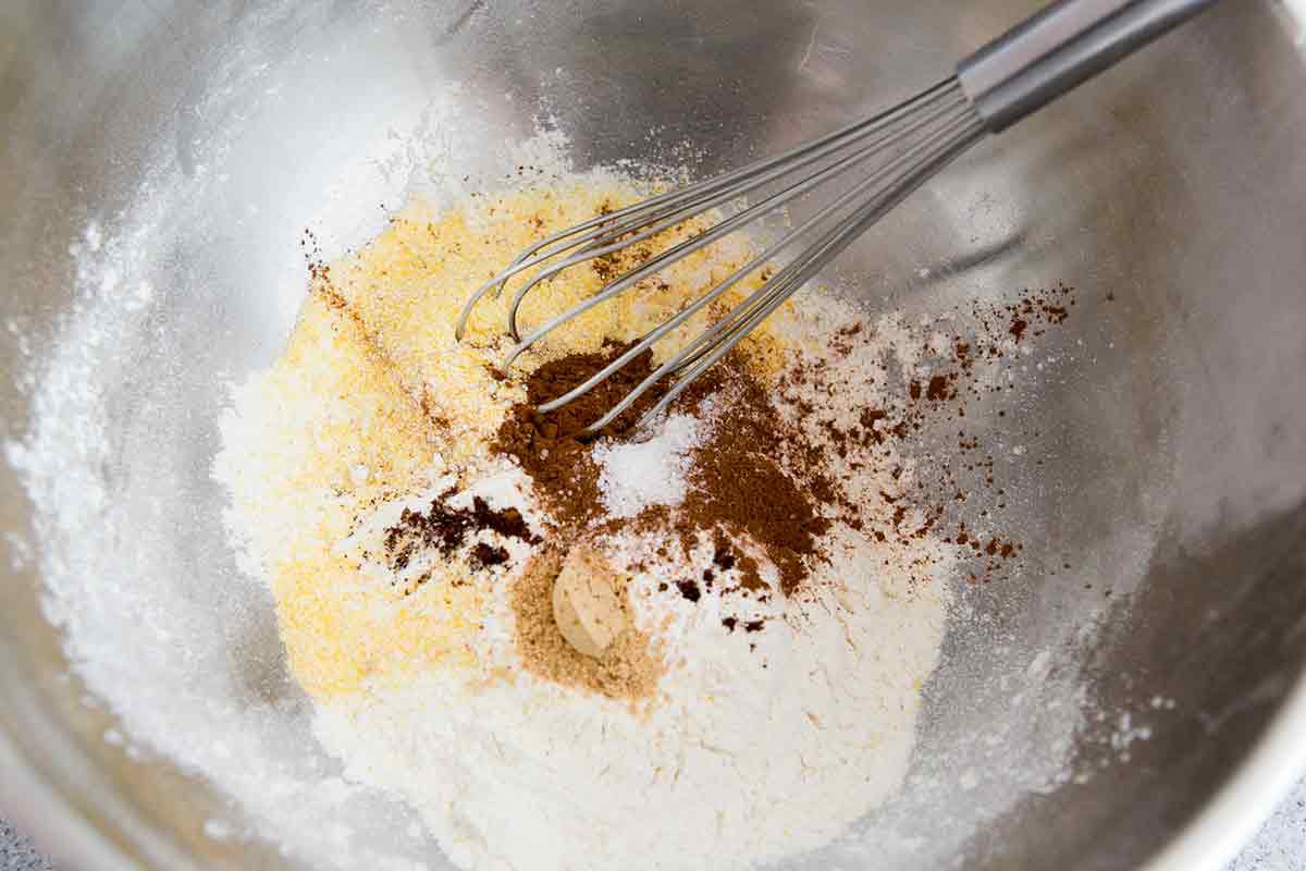 mixing dry pumpkin waffle ingredients in bowl