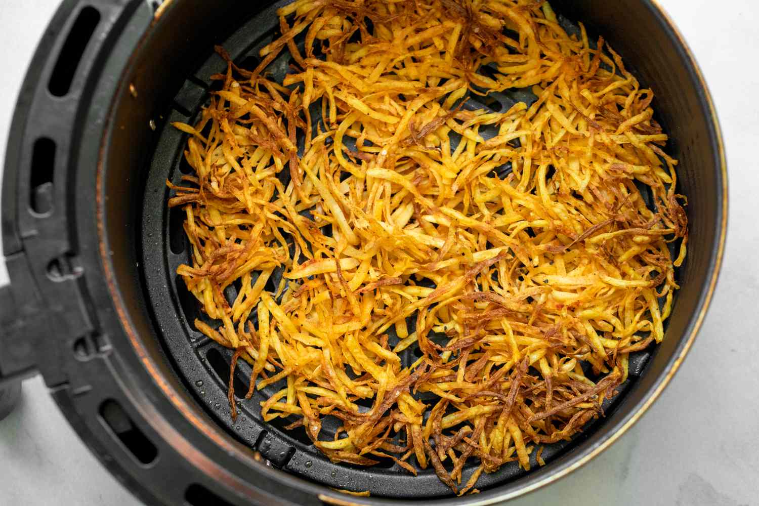 Air Fryer Hash Browns in Air Fryer Basin