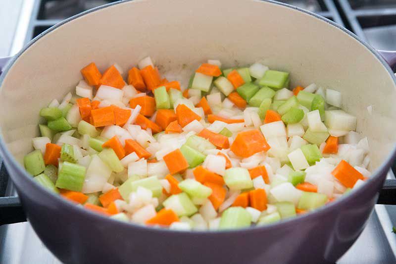 Diced carrots, celery, and onions in a Dutch oven