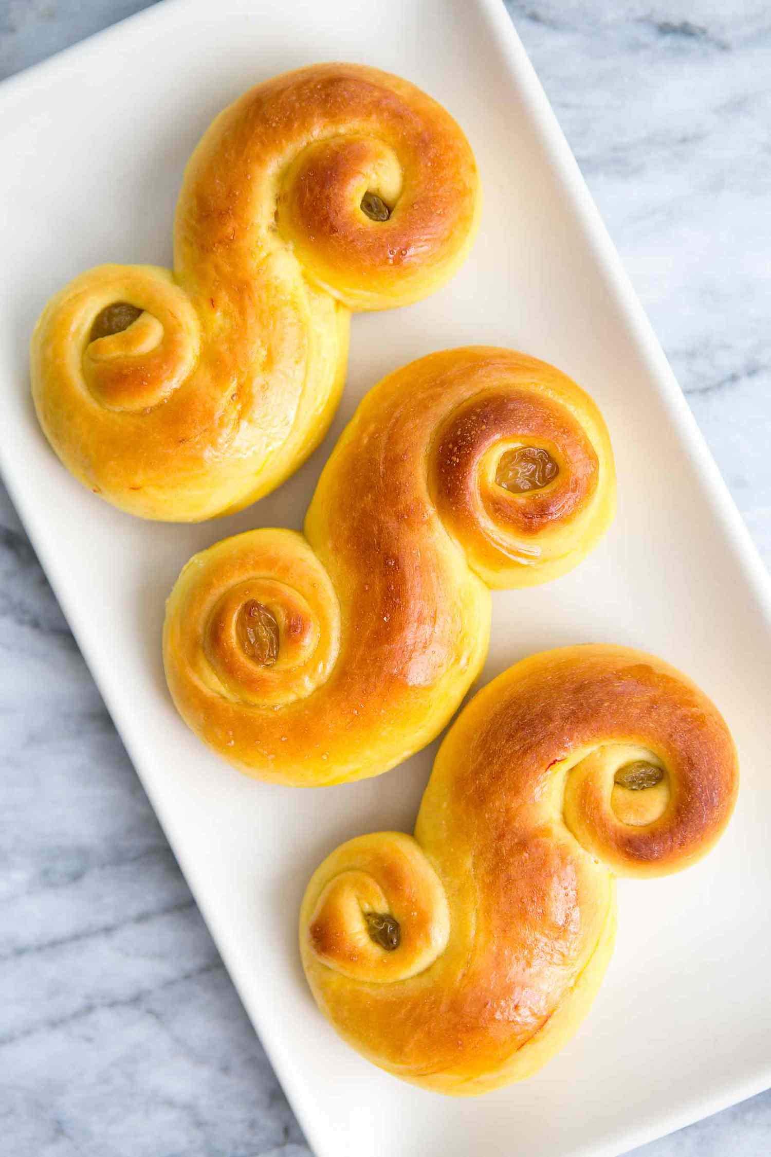 A plate of 3 st. lucia buns ready to eat.