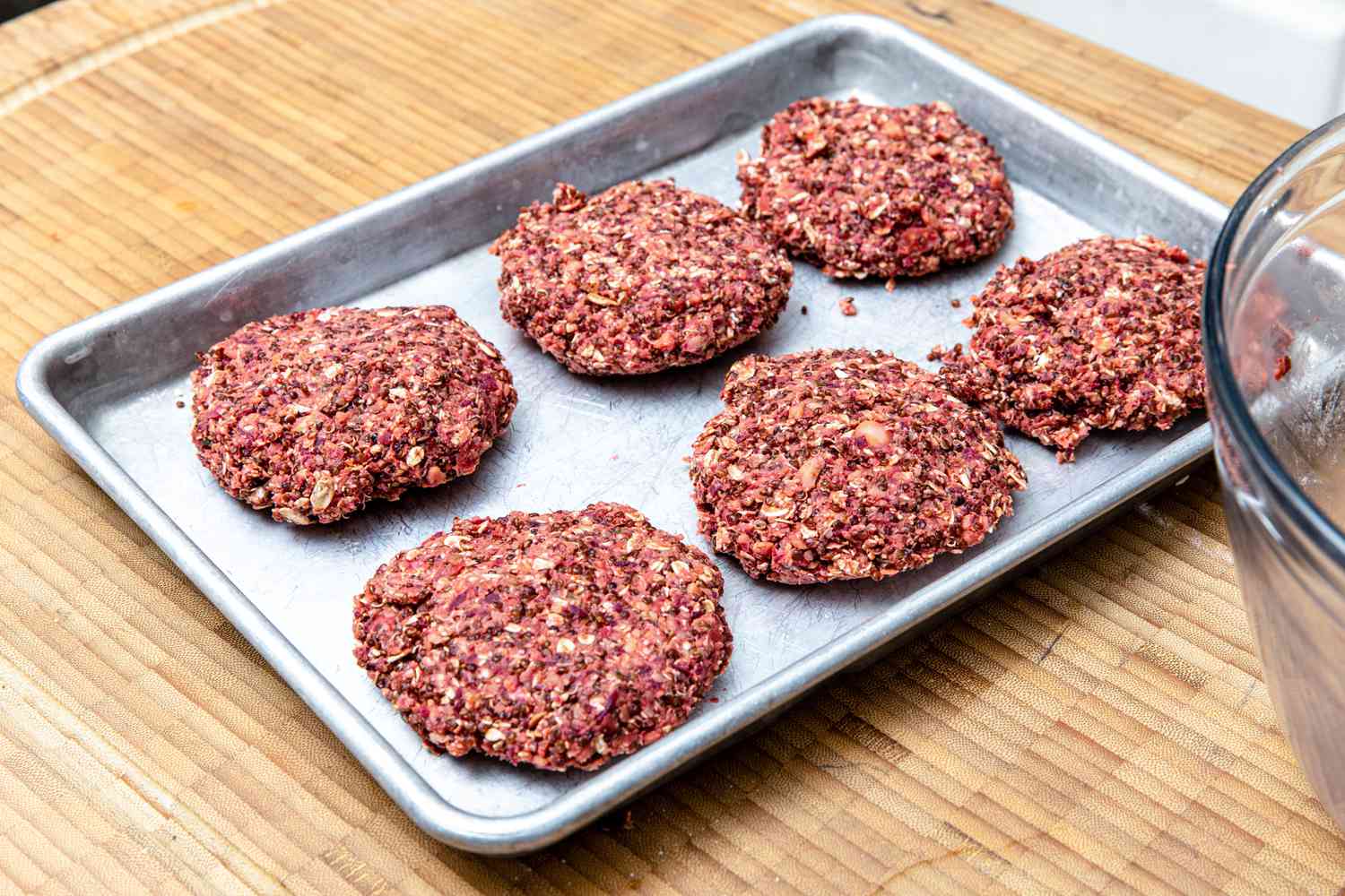 Six Veggie Burger Patties Resting on a Baking Sheet 