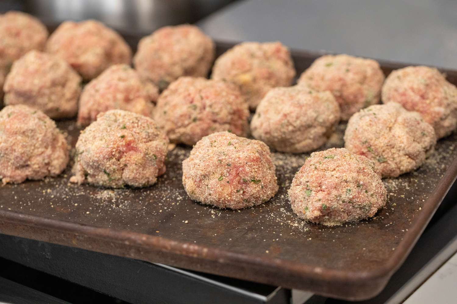 Breaded Meatballs on a Baking Tray for Meatball Sub Recipe