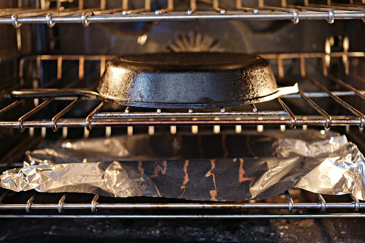 How to Clean a Cast Iron Skillet - cast iron skillet upside down in oven