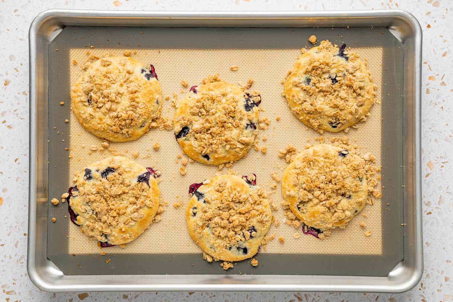 Baked Blueberry Muffin Tops on a Silpat Lined Baking Sheet