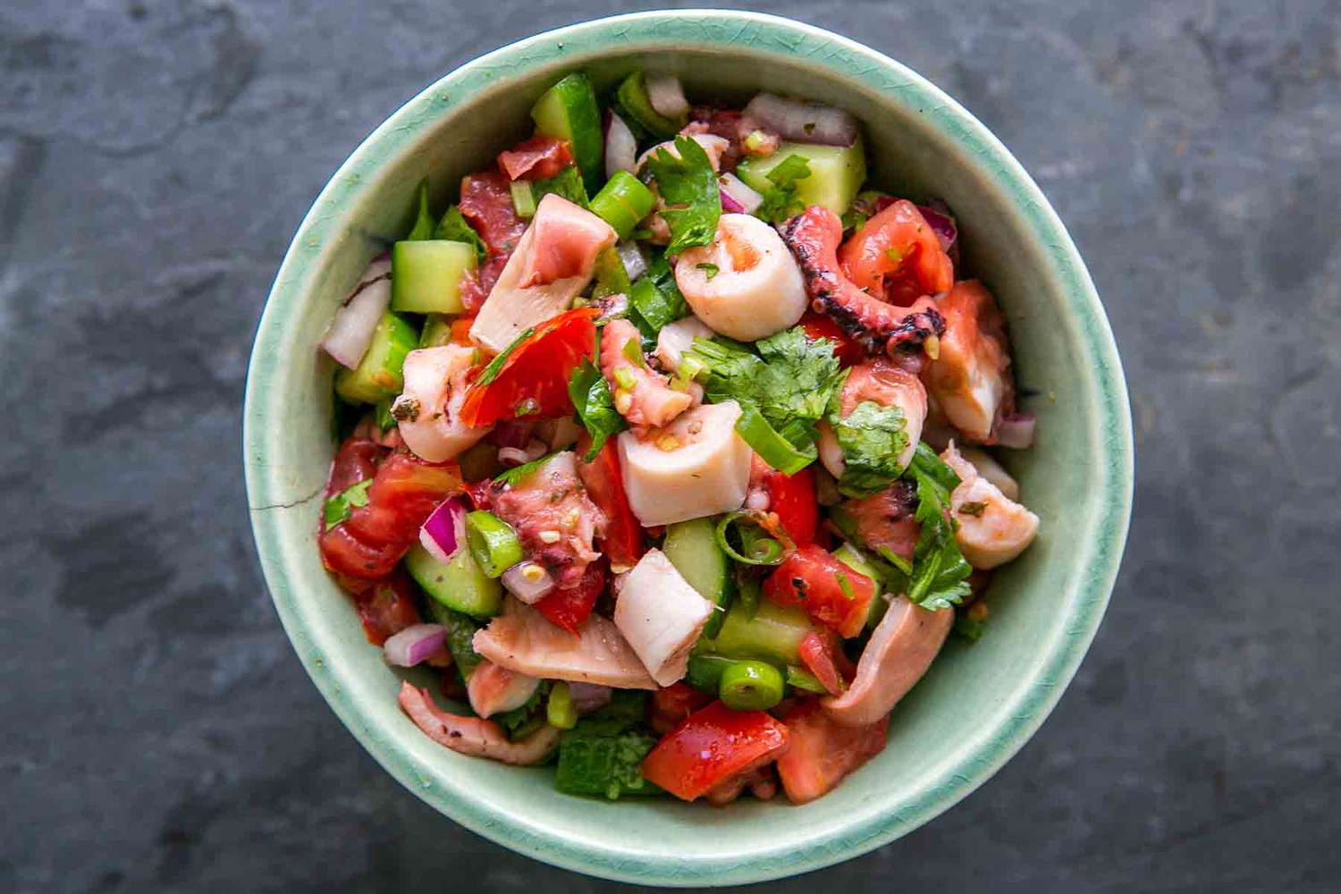 octopus salad with vegetables in a bowl