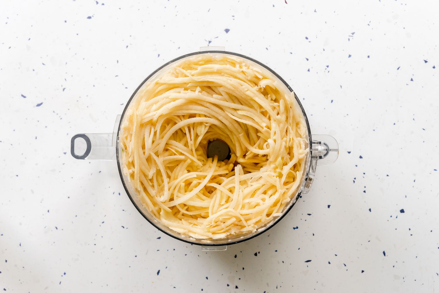 Potatoes Grated in a Food Processor for Potato Kugel Recipe