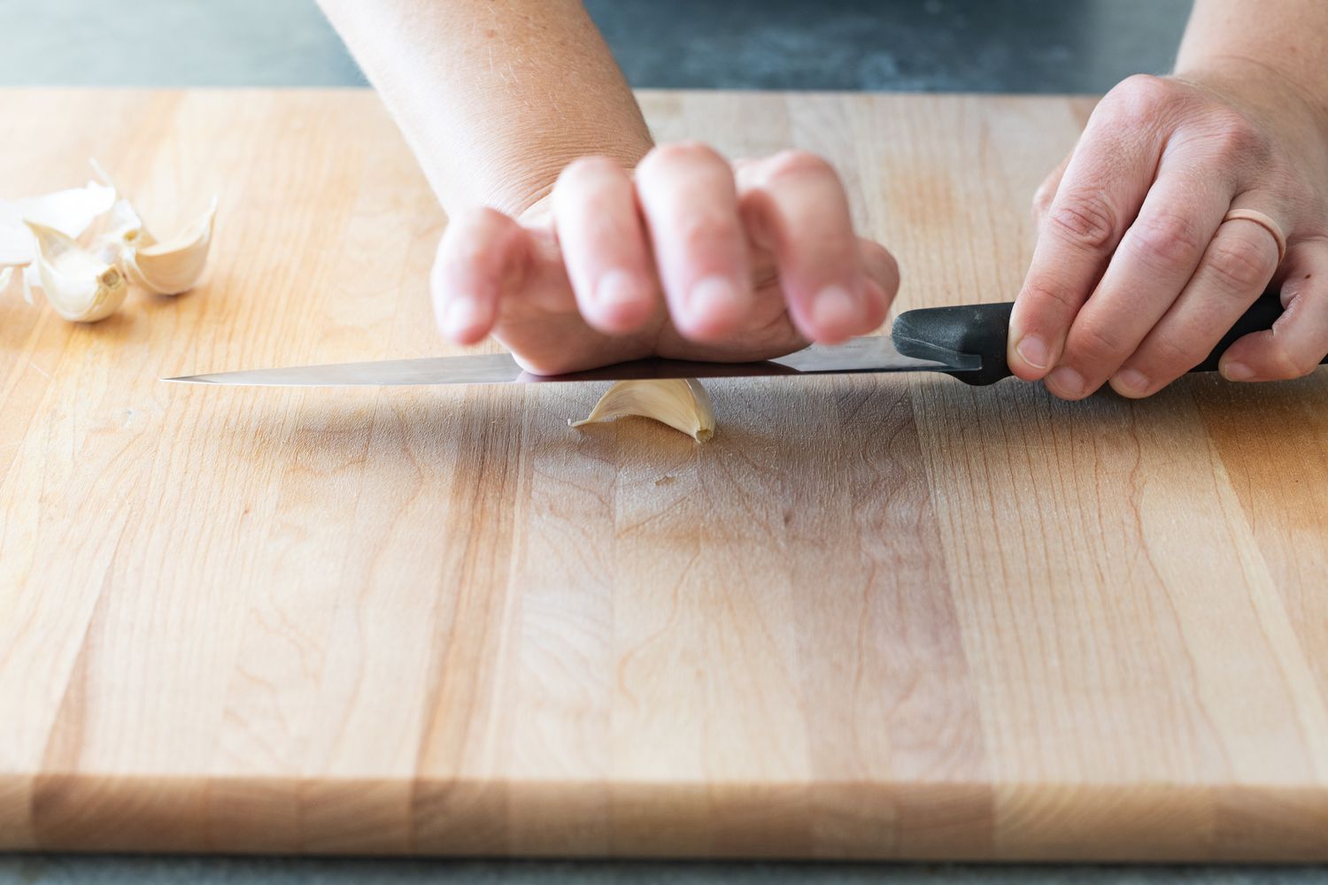 Smashing garlic clove with knife