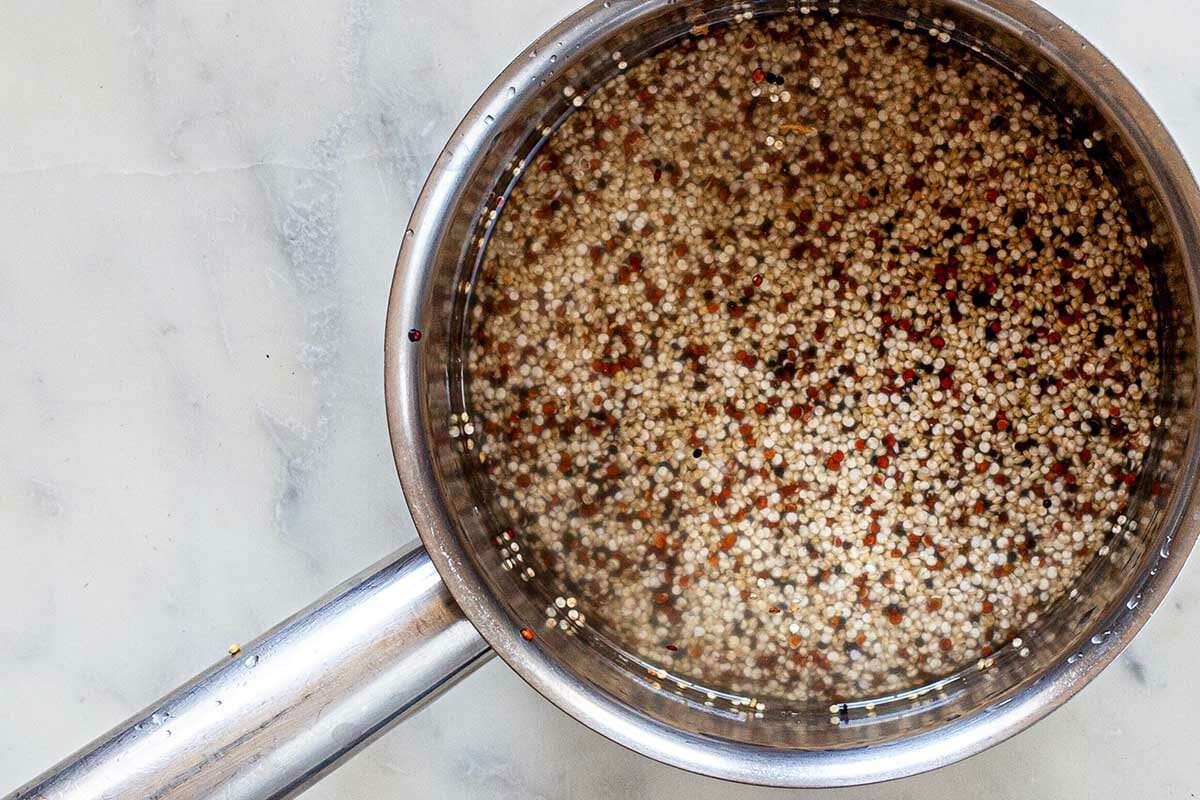 Quinoa in a saucepan to show how to cook perfect quinoa.