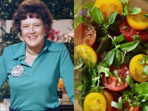 Julia Child shown alongside a salad with cherry tomatoes and fresh greens