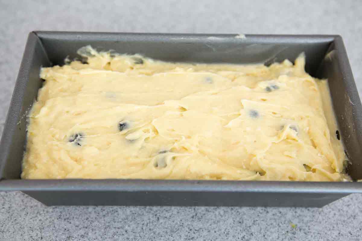 pour lemon blueberry ricotta poundcake batter into loaf pan, smooth top