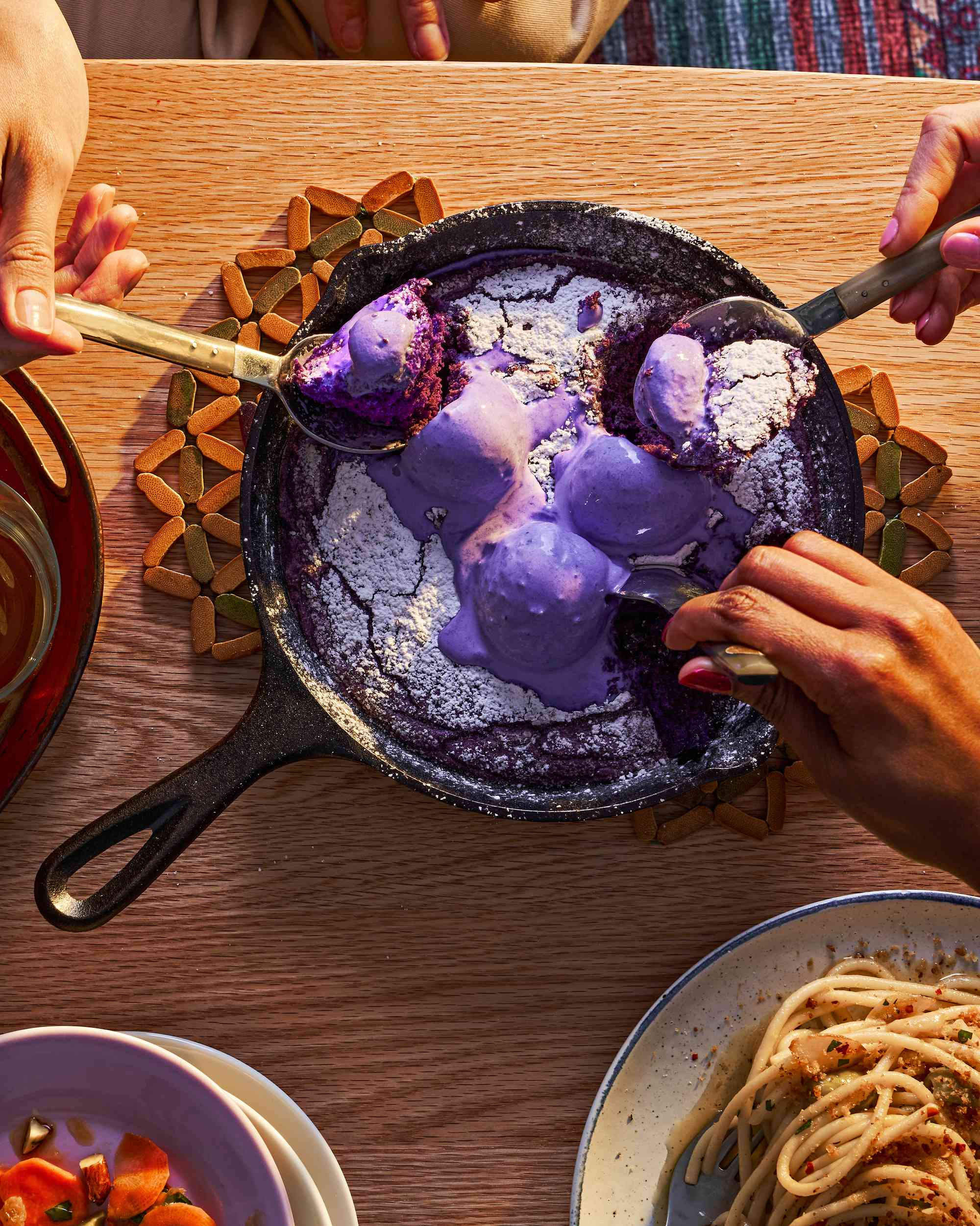 Spoons digging into an ube skillet cookie