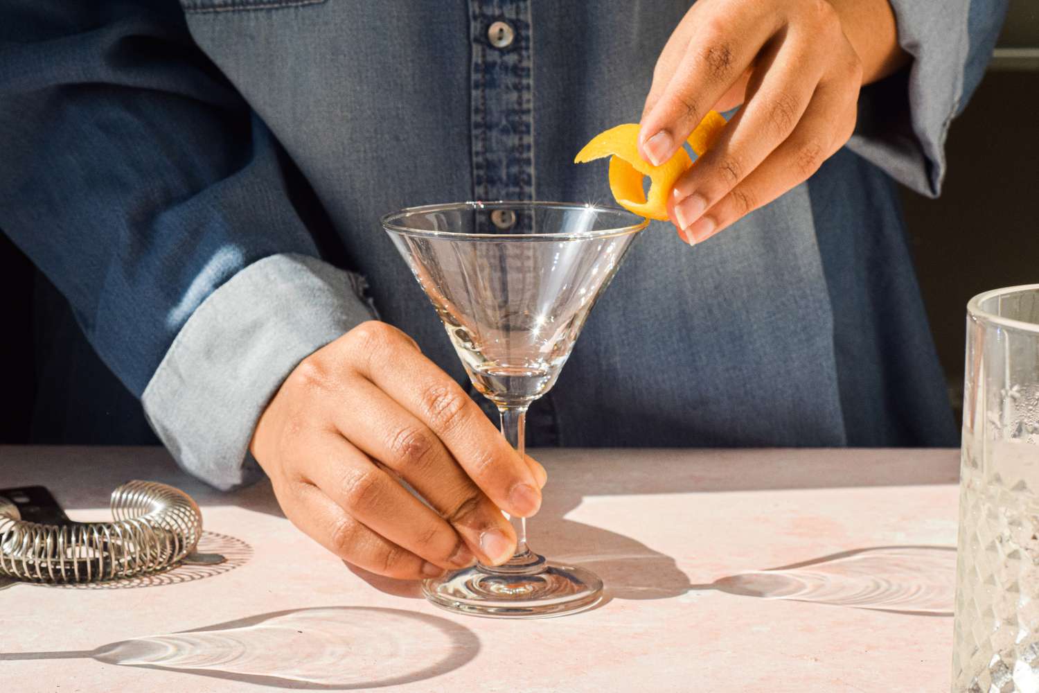 Lemon peel rubbed on rim of cocktail glass for martini with vodka recipe