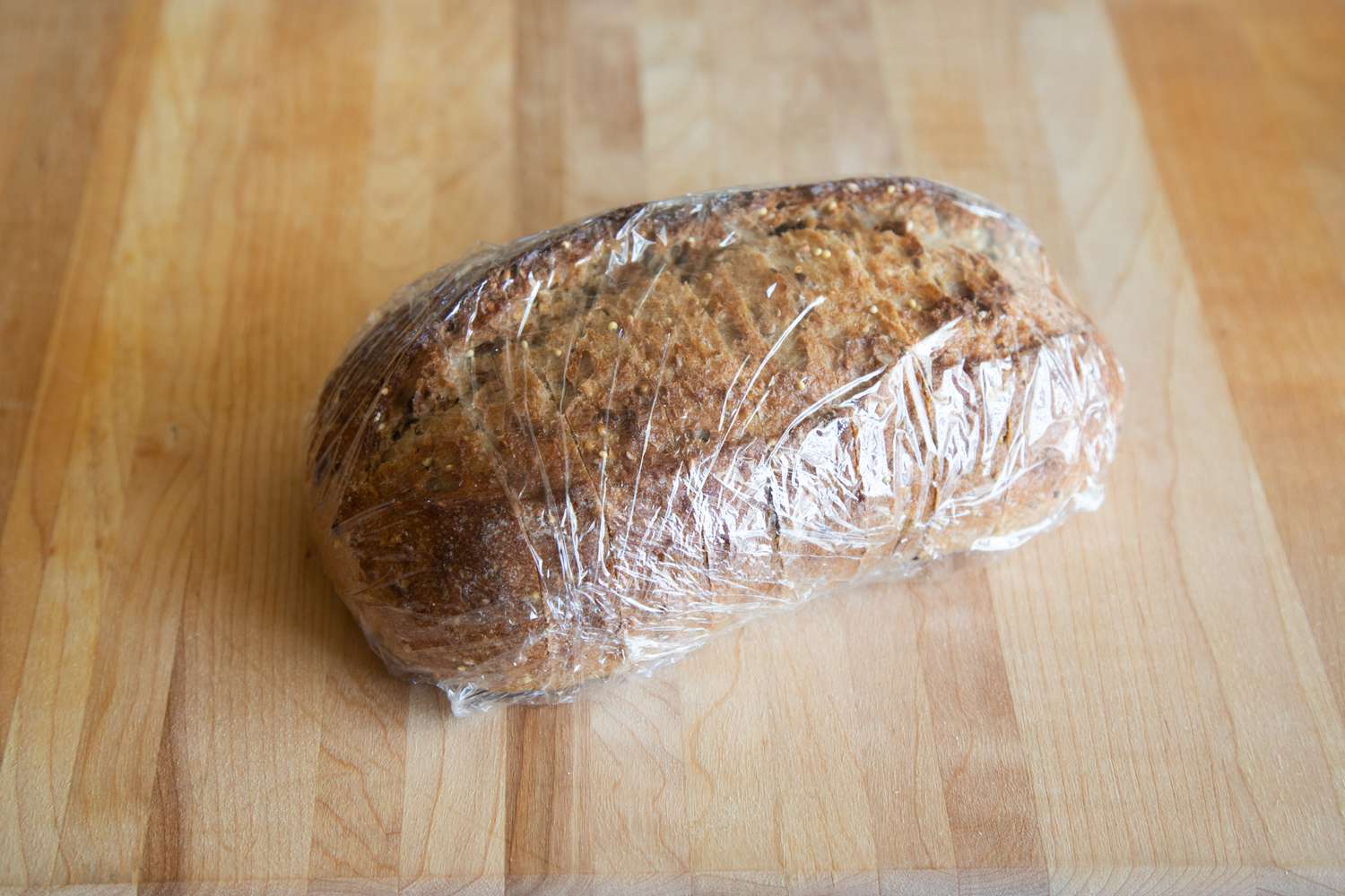 Bread loaf wrapped in plastic wrap