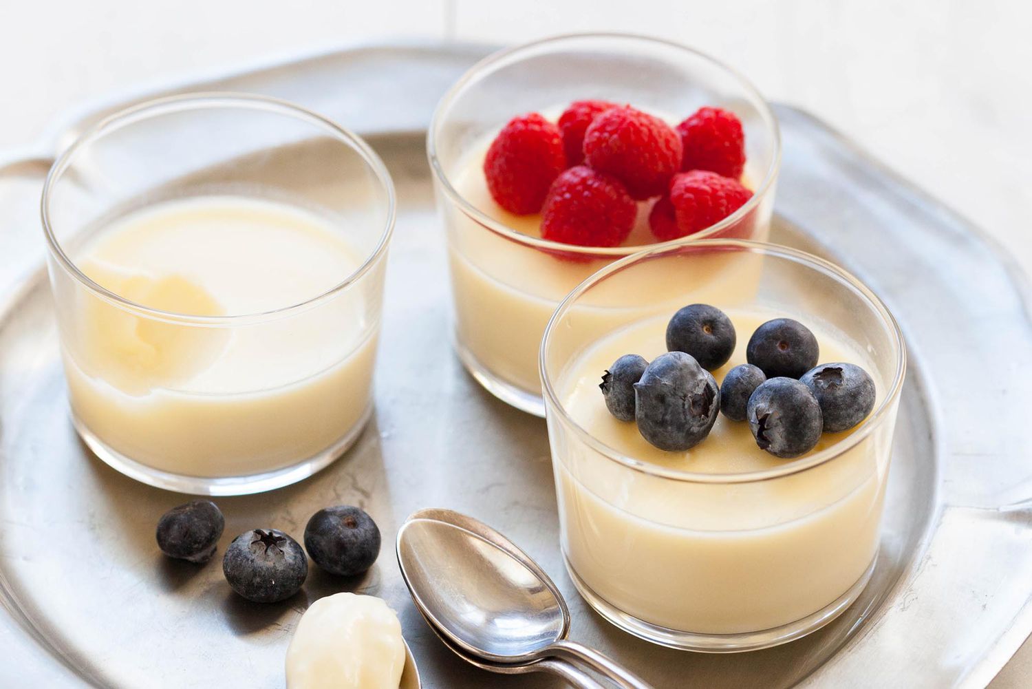 lemon pudding in cups with raspberries and blueberries