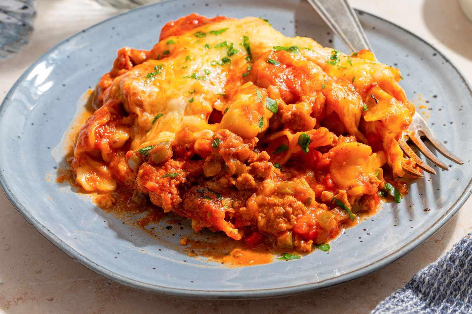 One serving of Tortellini Pasta Bake on a plate with a fork