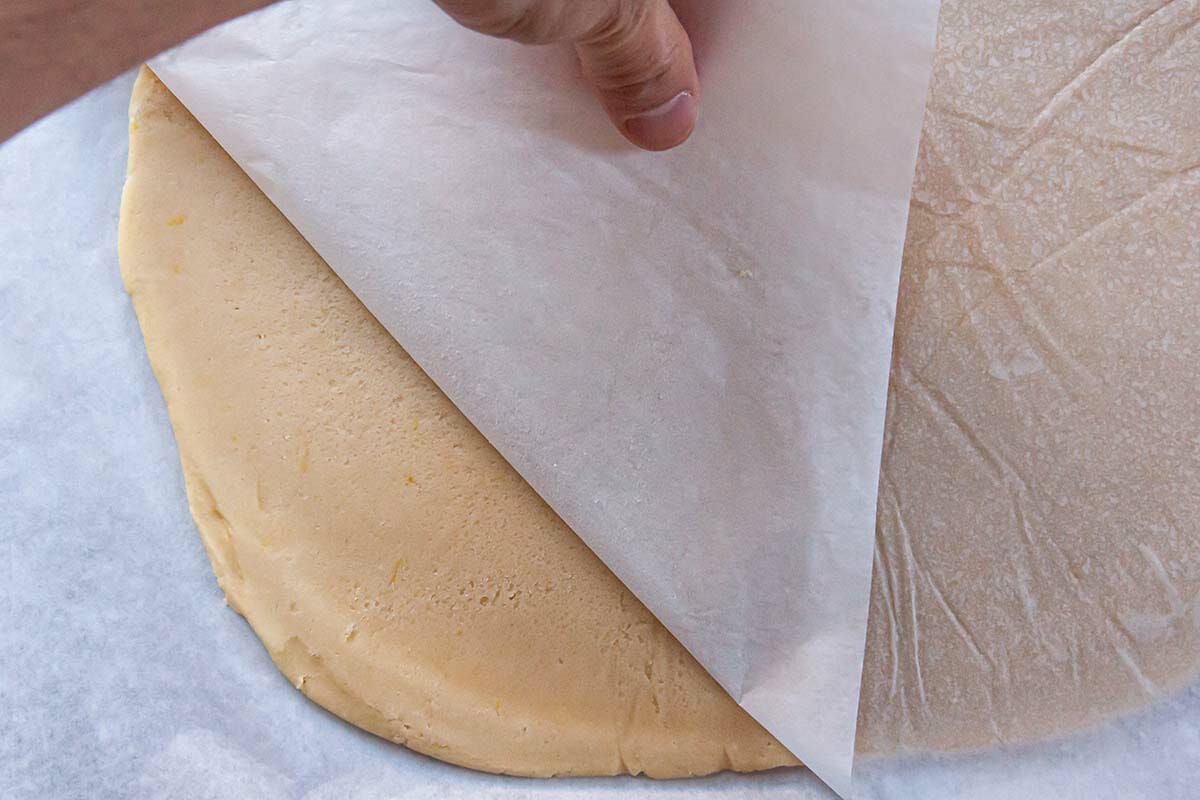 Removing parchment from rolled out dough for Sugar Cookies.