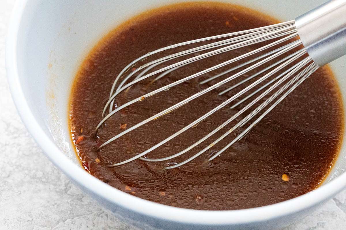Whisking a sauce for One Pot Vegetarian Stir Fry.