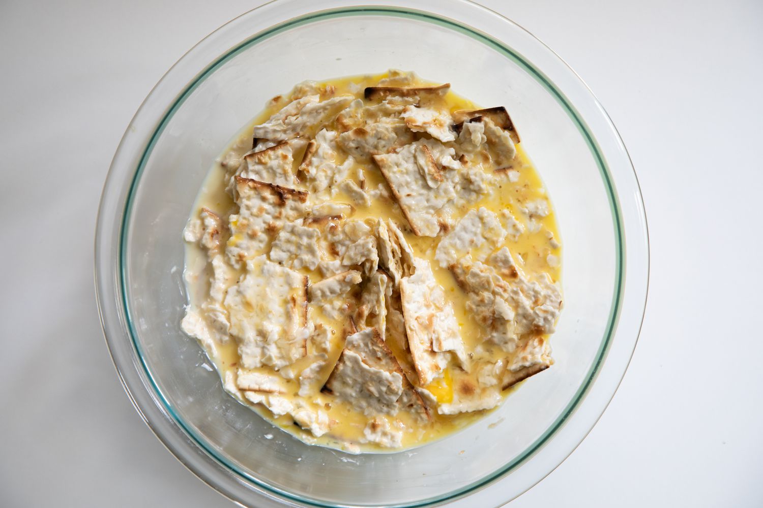 matzah brei soaking in a bowl