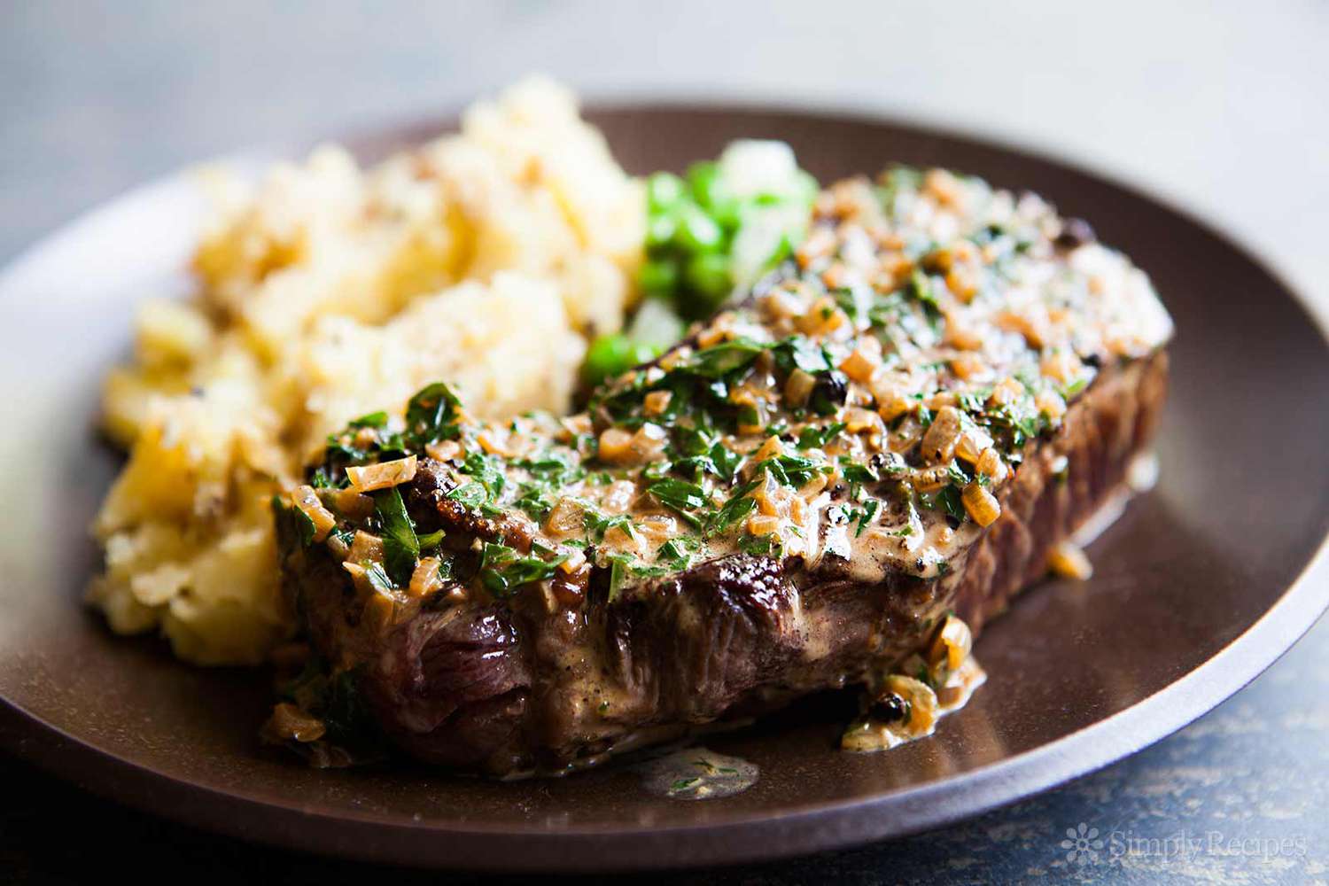 peppercorn steak with a side of mashed potatoes