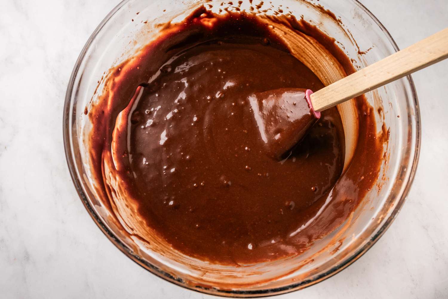 chocolate cake batter in a bowl with a spatula for earthquake cake recipe