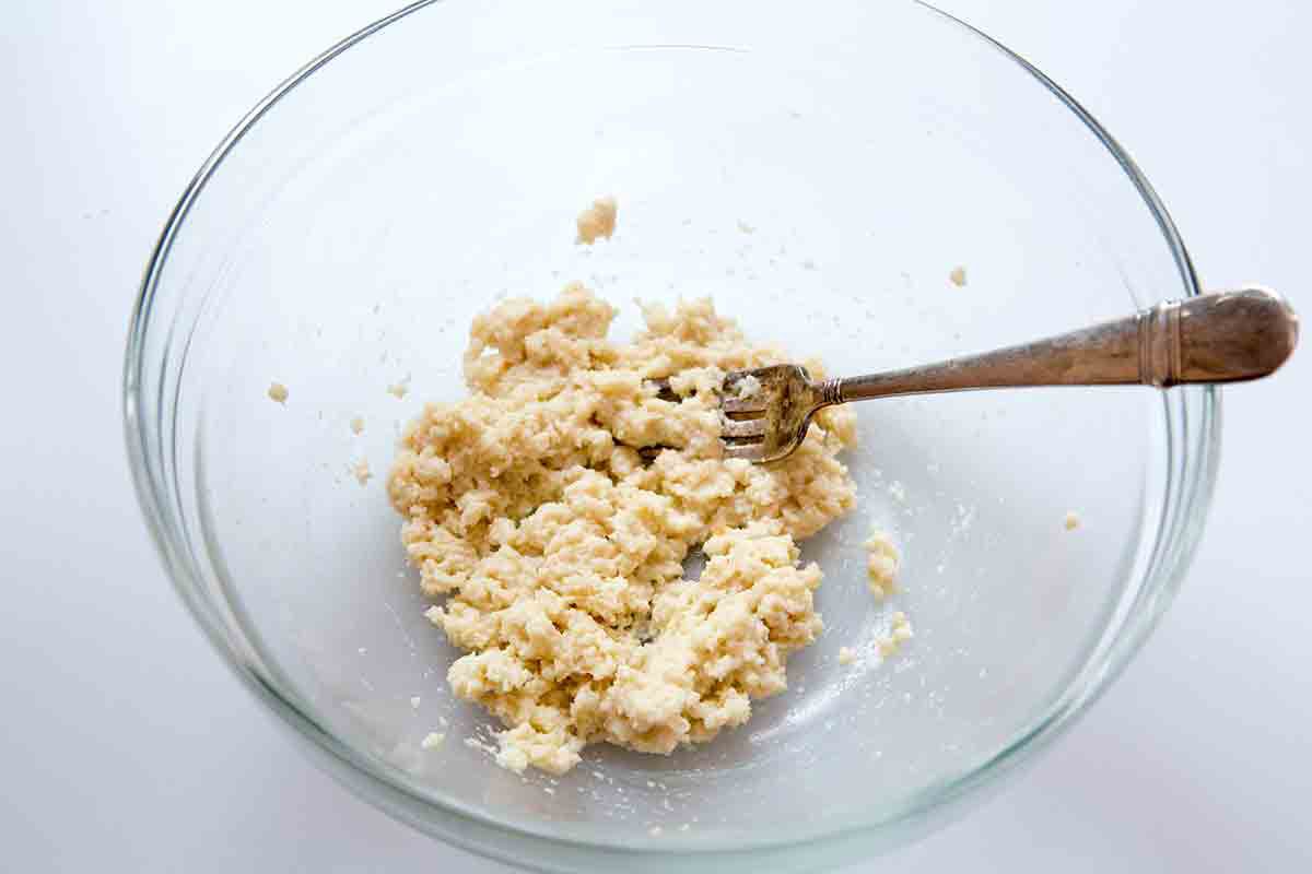 Shredded bread that has been soaked in milk resting in a bowl