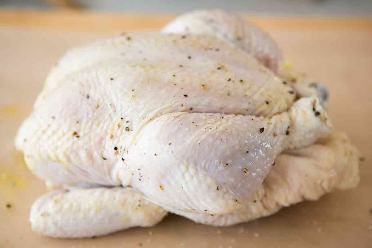 seasoned whole chicken ready to be roasted