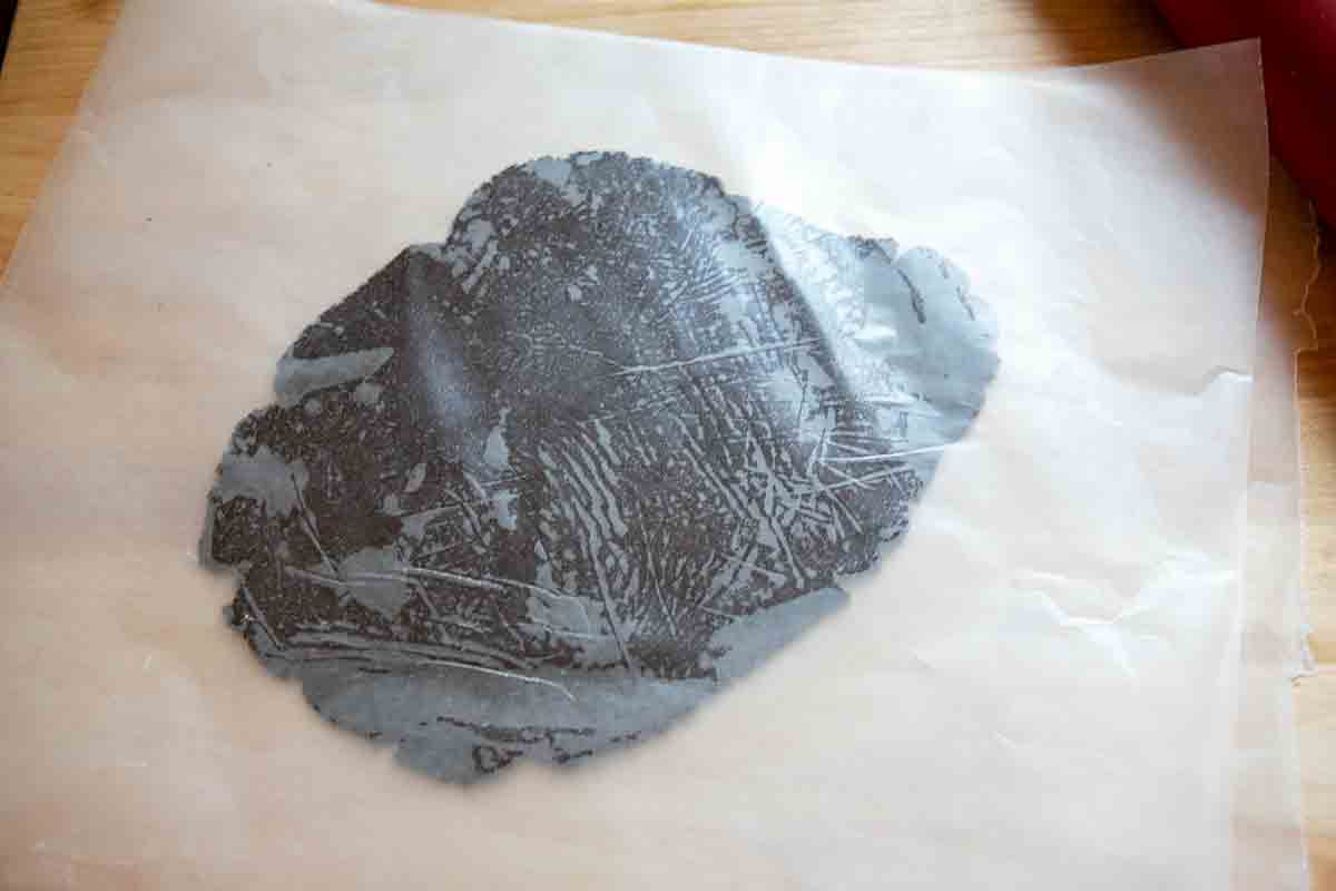 rolling out dough between parchment paper
