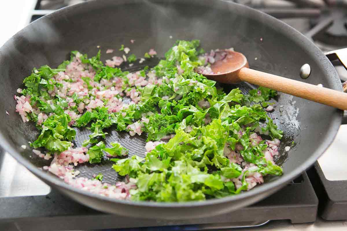 sautéing kale in a pan