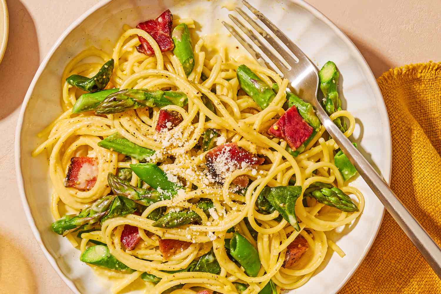 overhead view of a plate of Spring Carbonara with a fork