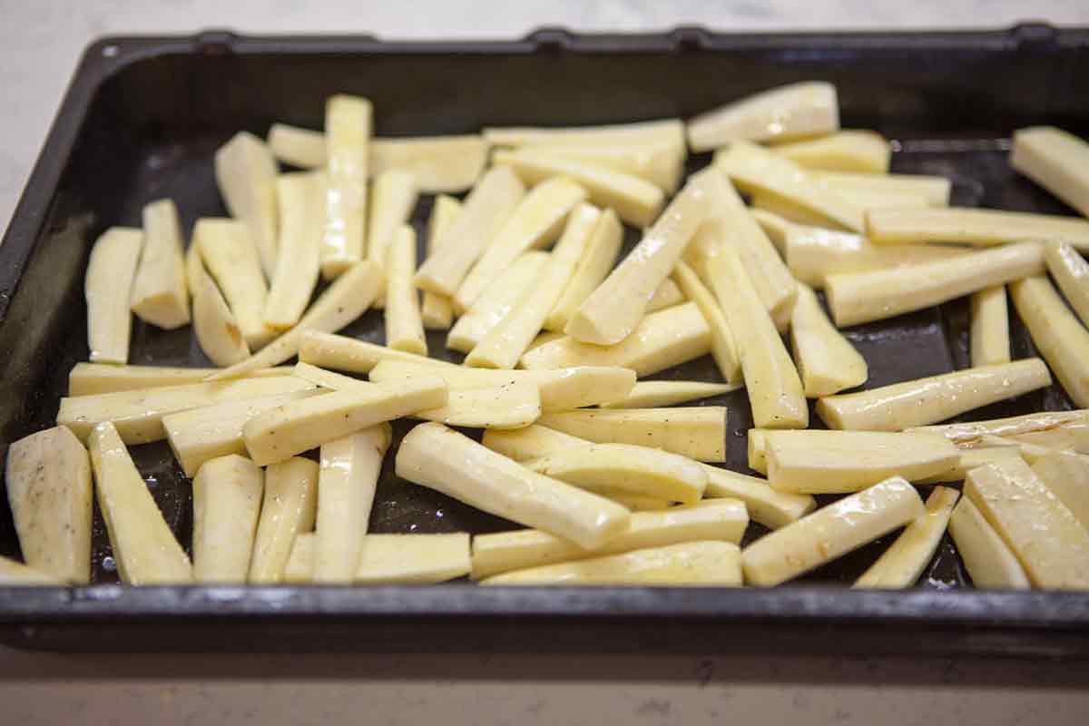 How to cook parsnips by roasting in a baking sheet.