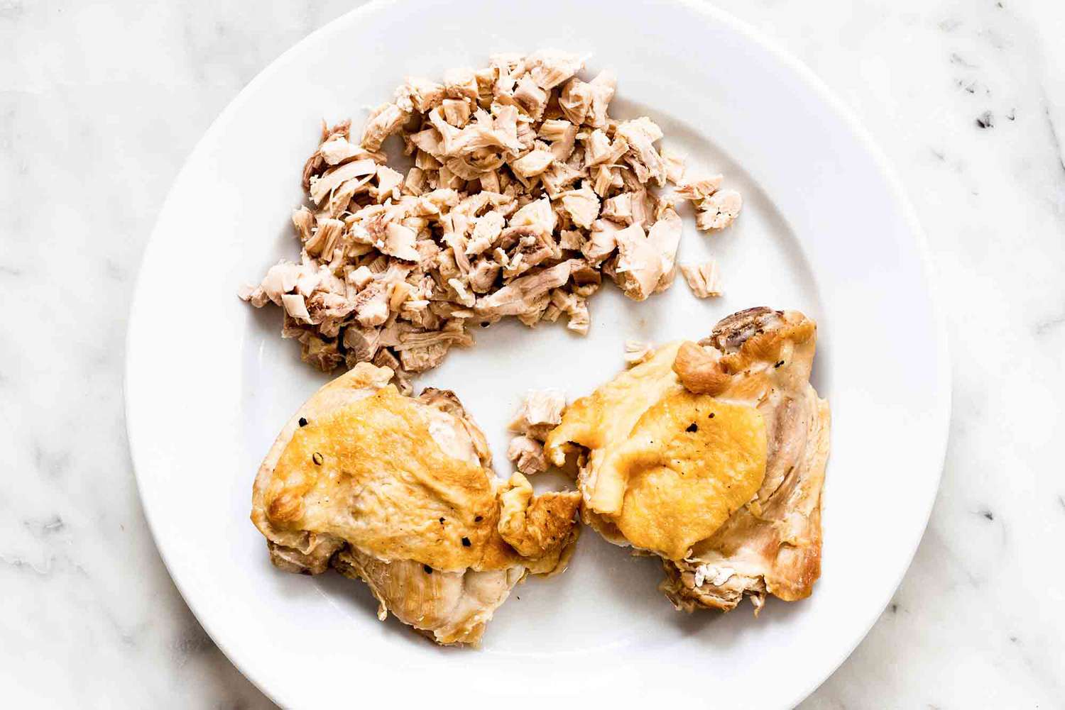 Small bits of cooked chicken removed from bone and without skin